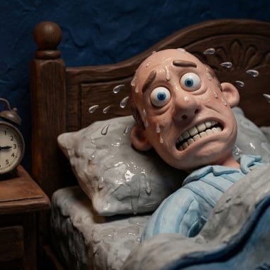 Image of hangover night sweats showing a claymation character drenched in sweat at 3 AM.