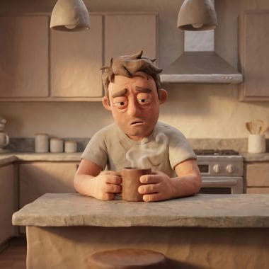 Image of coffee for a hangover — a claymation man cradling a mug of coffee the morning after.